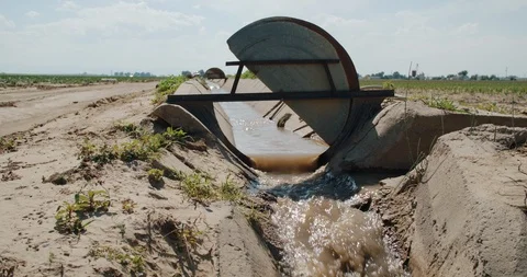 Irrigation ditch with head gate open to control flow Stock Footage 120621811