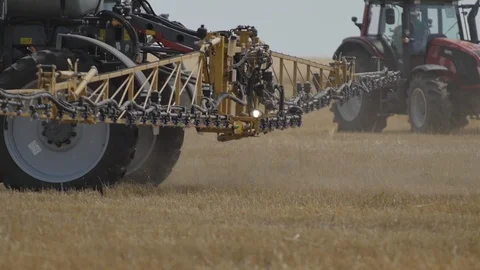 Irrigation of the Field on the Tractor Stock Footage 111880379