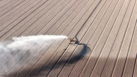Irrigation pivot gun machine spraying water seen from above Stock Footage 333313921