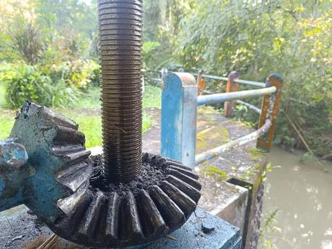 An irrigation sluice gate located on a small dam. Stock Photos