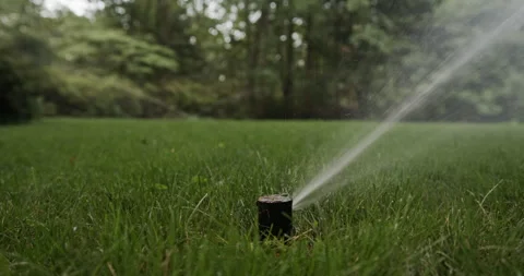 Irrigation system sprinklers, low angle, green grass, audio. Stock Footage 137932262