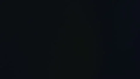 The irrigation system stands tall in the corn field, silhouetted against the Stock Footage 320063446