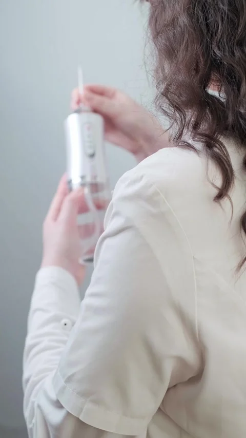 Irrigator as part of daily routine: tips from a professional dentist for Stock Footage 307304042