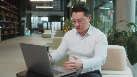 Irritated businessman while working on laptop, computer virus data loss by Stock Footage 317915247