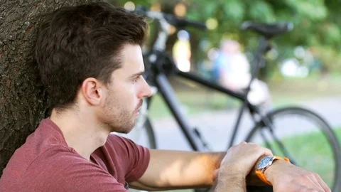 Irritated man checking time on wrist watch and waiting for someone who is late 스톡 동영상 69963713