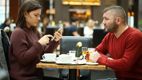 Irritated man notices someone while having lunch with his daughter Stock Footage 74901472
