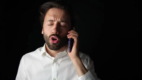 Irritated man talking on the phone Stock Footage 285090376