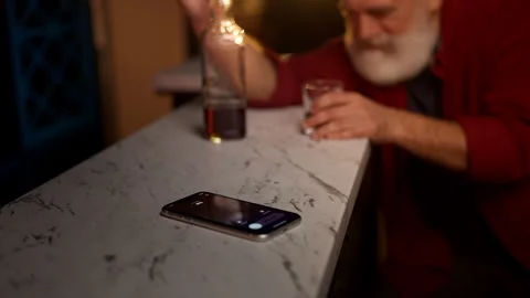 IRS calls as middle-aged man drinks alcohol alone, debt and financial crisis Stock Footage 342520327