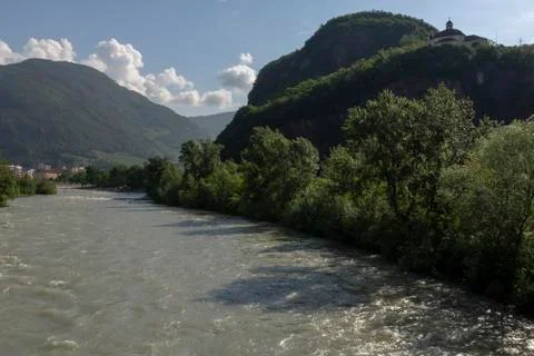 Isarco river in spring time with mountains and a blue sky in background Stock Photos
