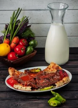 Iskende kebab beef slice garnished with tomato sauce, served with tomato, pepper Stock Photos