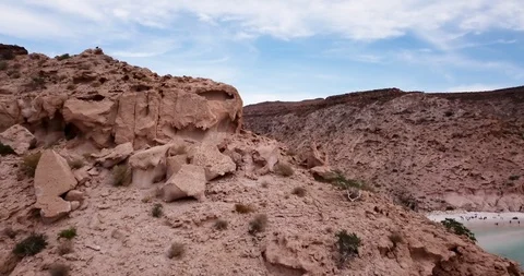 Isla Espiritu Santo Drone 4K UP and Over Rock Cliff Onto Beach Cove Stockbeeldmateriaal 95699402