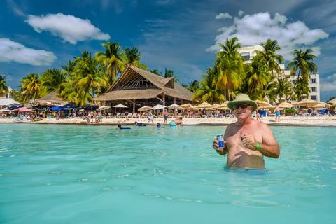 ISLA MUJERES ISLAND, MEXICO - APR 2022: Happy man with an energy drink cockta Stock Photos