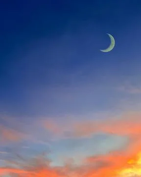 Islamic background with crescent moon in evening with colorful dusk sky. Stock Photos