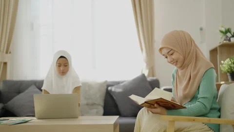 Islamic concept of 4k Resolution. A Muslim mother is reading the Holy Quran.. Stock Footage 322682295