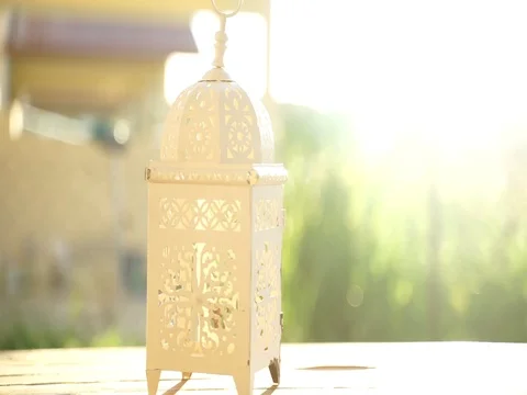 Islamic lamp cover on the table with stunning sunrise. Bright sunny day.  Stock Footage 112605304