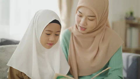 Islamic learning concept of 4k resolution. Muslim Asian mother sitting with.. Stock Footage 309301984