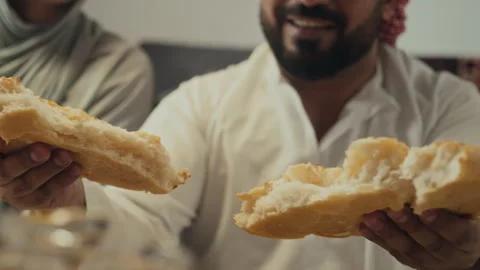 Islamic Man Breaking Bread and Sharing with Relatives on Sweet Eid Stock Footage 266312991