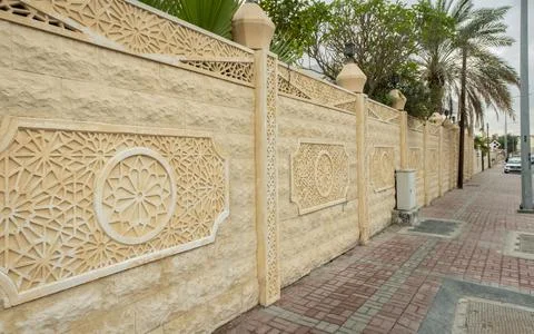 Islamic middle eastern wall pattern on a yellow compound wall in doha, Qatar Stock Photos