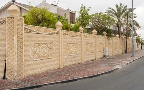 Islamic middle eastern wall pattern on a yellow compound wall in doha, Qatar Stock Photos