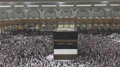 Islamic pilgrims performing Tawaf around the sacred Kaaba building in Mecca Stock Footage 340194699