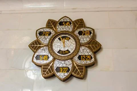 Islamic prayer time clock inside Sheikh Zayed Mosque Stock Photos
