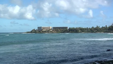 Island beach waves roll onto sand on empty shore Video stock 125340311