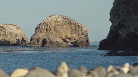 Island with a cave in the ocean Stock Footage 88285629