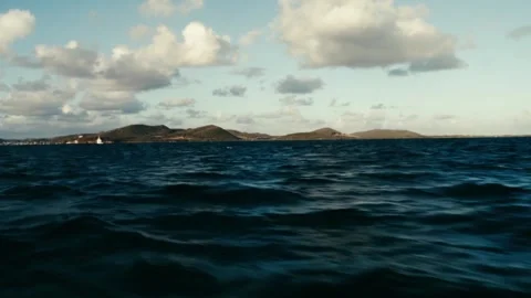 Island on the horizon with strong current Stock Footage 259905744