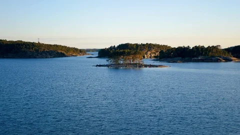 Island In Light Of Sunset With A Coniferous Forest And Rock Coast In North Sea Stock Footage 102045825