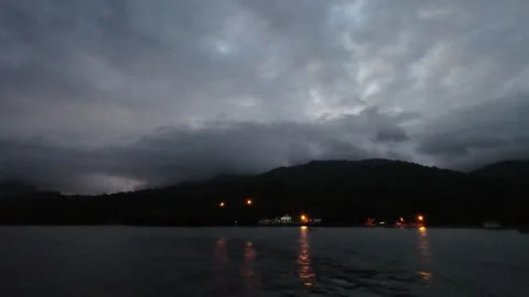 Island lights during dusk viewed from ship, Aceh Indonesia. Video stock 321129986