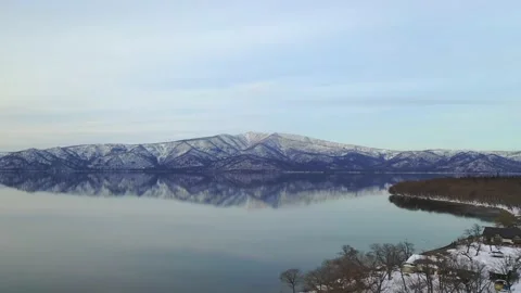 Island reflection upon calm still water of a winter lake Stock Footage 155918266