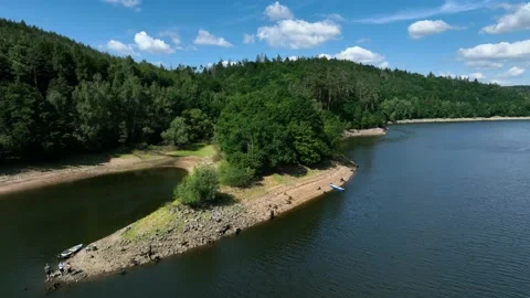 An island with a small forest and a beach on a water dam in the Czech republic Stock Footage 228435637