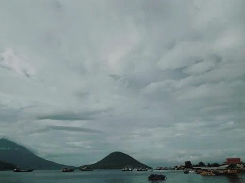 An island under the cloudy sky Stock Photos