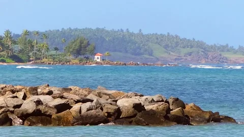 Island View of Beach with Big Rocks Mountains in the Background Stock Footage 221930789