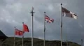 Isle of Man and British flags waving in the wind. Manx flags HD Footage