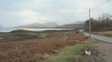 Isle of Mull - Mountains - Blue Van driving into distance 動画素材 86112685