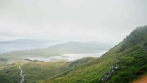 Isle of skye landscape with dramatic mountains and foggy loch Stock Photos