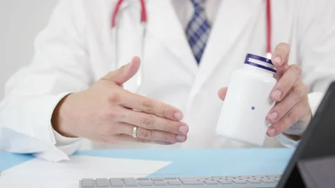 ISOFLAVONES, a generic supplement, in the bottle in doctor's hand Stock Footage 137208433