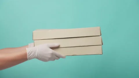Isolate background, Asian delivery man holding pizza box and giving to customer. Stock Footage 164938619