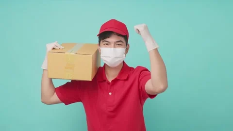 Isolate background, Asian delivery man in red uniform holding box on shoulder. Stock Footage 164938637