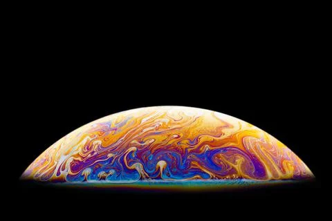 Isolate. Bright, iridescent patterns on the surface of the soap bubble. Stock Photos