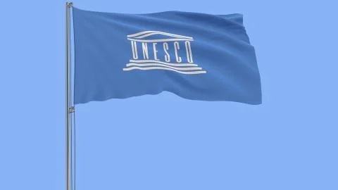 Isolate flag of the UNESCO on a flagpole fluttering in the wind on a blue Stock Illustration