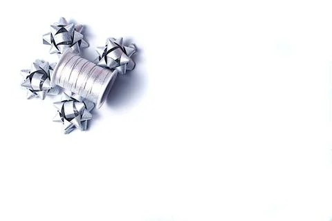 Isolate of silver ribbons and four bows. Ribbons for gift wrapping. flat lay. Stock Photos