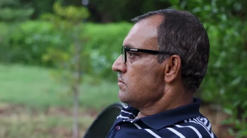 Isolated alone man head closeup shot at outdoor park at evening from flat ang Stock Footage 282439314