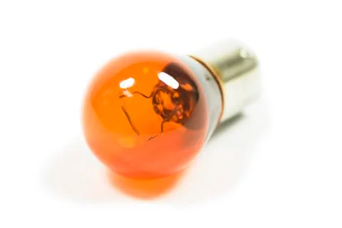 Isolated amber lightbulb Stock Photos