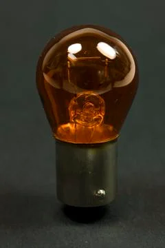 Isolated amber lightbulb Stock Photos