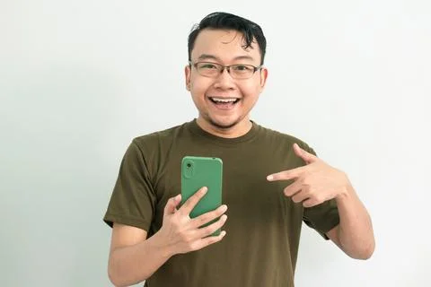 Isolated Asian Guy Using Smartphone Stock Photos