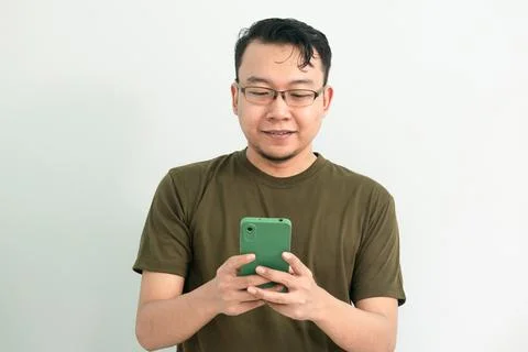 Isolated Asian Guy Using Smartphone Stock Photos