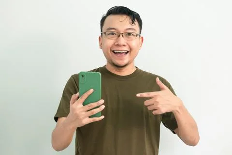 Isolated Asian Guy Using Smartphone Stock Photos