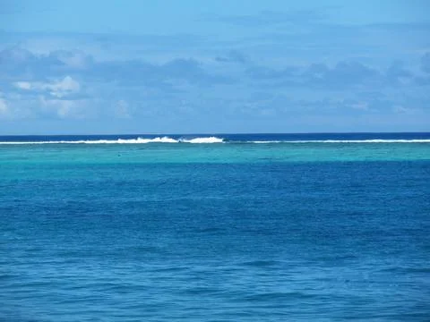 An isolated beach with ocean waves and sky Stock Photos